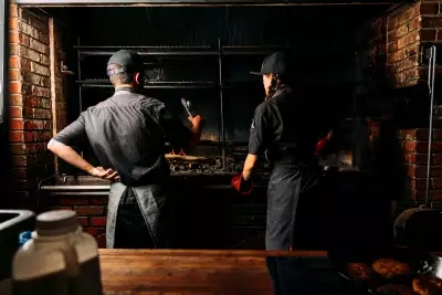Outdoor dining experiences in Canada | Cooks grilling over fire at The Fireworks Feast in Souris, P.E.I.