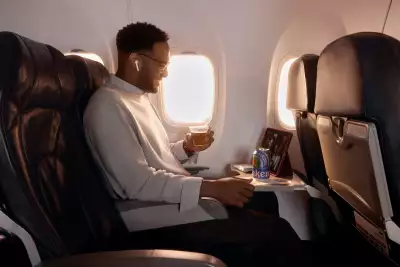 Someone enjoying a non-alcoholic beer on an Air Canada flight