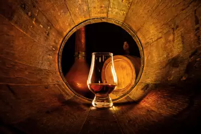 Canadian whisky | A glass of whisky inside a barrel