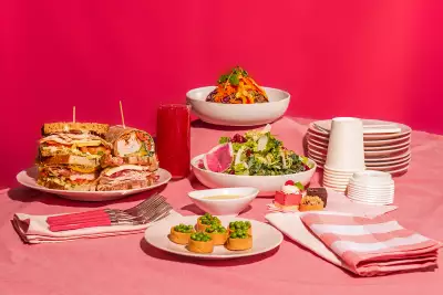 Dishes from O&B against a pink backdrop