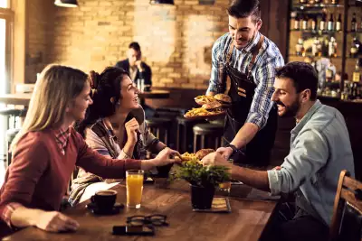 Win a Visa gift card | A group of friends at a restaurant