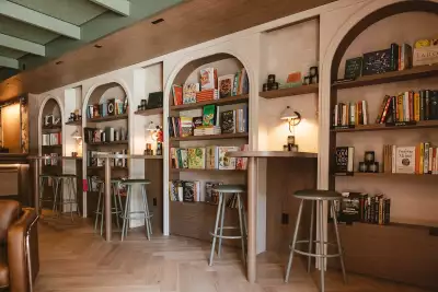 Best caf&eacute;s and coffee shops in Toronto | Shelves of books and stools at Book Bar