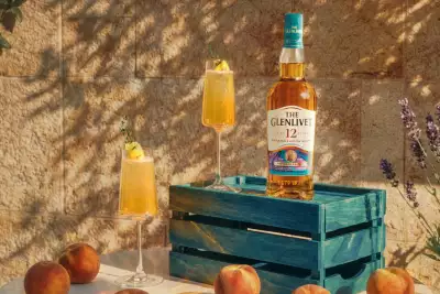 The Glenlivet 12 Year Old Beyond Speyside Series: Provence Edition on a crate with two sparkling cocktails