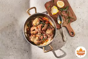 A pot of quail and a cutting board with lemons