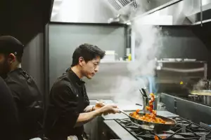 Best restaurants Toronto | A chef flips a pan of pasta at DaNico