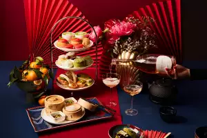 A cake stand of treats, bamboo steamer baskets, tea and sparkling wine at Holts Café Lunar New Year Afternoon Tea