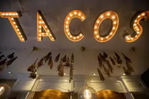 The neon TACOS sign inside La Bartola in Toronto The neon TACOS sign inside La Bartola in Toronto