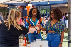 People being served wine at the Spring into Spice food and wine festival Toronto