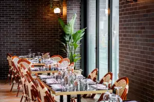 La Plume Toronto | Set tables with bistro chairs at La Plume in The Well La Plume Toronto | Set tables with bistro chairs at La Plume in The Well