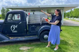 13th Street Winery, Niagara | Renée Sferrazza sabring a bottle at 13th Street Winery in Niagara