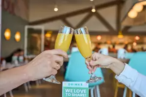 Best brunch and breakfast in Toronto | Guests cheersing with two mimosas