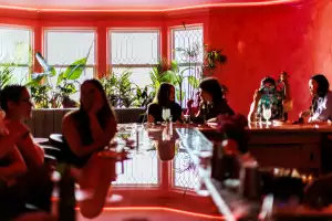 The best bars in Toronto | Guests enjoying cocktails at the bar at Le Tigre