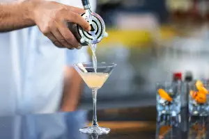 Pouring a martini into a glass Pouring a martini into a glass