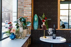 New restaurants in Toronto | A table set with wine by the window at Piano Piano on Bloor