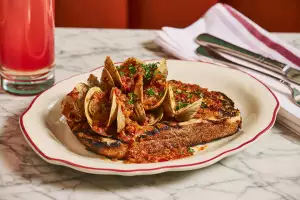 Best new Italian restaurants in Toronto | A shellfish dish on toast at Proper in Roncesvalles