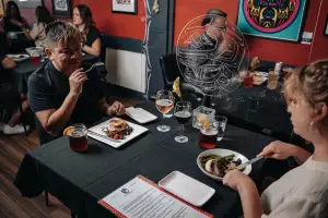 People eating in the dining room at Salmon n' Bannock in Vancouver
