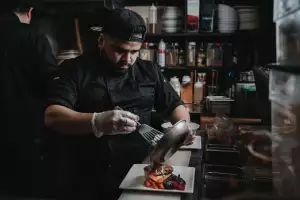 A chef cooking at Salmon n' Bannock in Vancouver