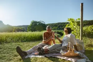 Nova Scotia wineries | A couple enjoy a glass in the vineyards at Benjamin Bridge in Nova Scotia