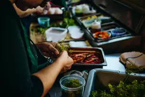 Farm-to-table dining in Qu&eacute;bec: A hand preps vegetables at Escape Old Mill