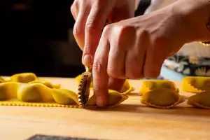 Pasta Privato Toronto | A hand cuts fresh ravioli with a ravioli wheel at Pasta Privato in Toronto