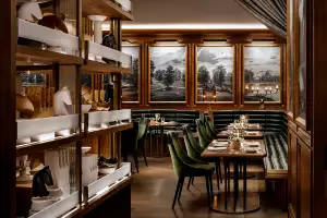 REIGN Toronto | The dining room at REIGN, with booths, a table and artwork decorating the interior