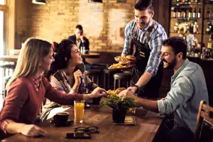 Win a Visa gift card | A group of friends at a restaurant