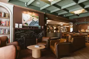 New Toronto restaurants | Comfy chairs and art on the wall at Book Bar Toronto