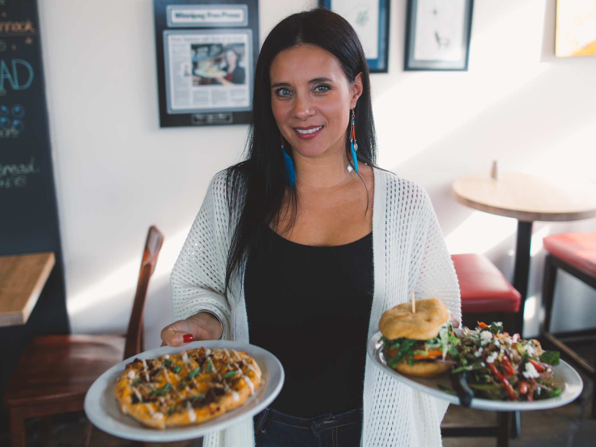 Manitoba restaurants | A server brings out dinner at Feast Manitoba restaurants | A server brings out dinner at Feast