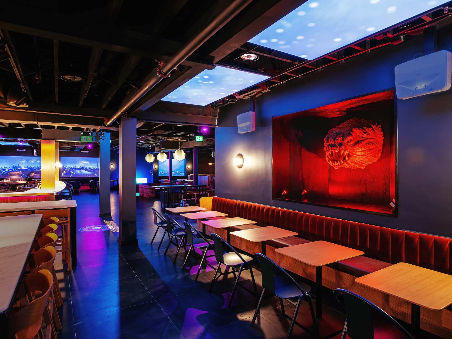 Offworld bar | The dining room and red alien head emerging from the wall at Offworld bar Offworld bar | The dining room and red alien head emerging from the wall at Offworld bar