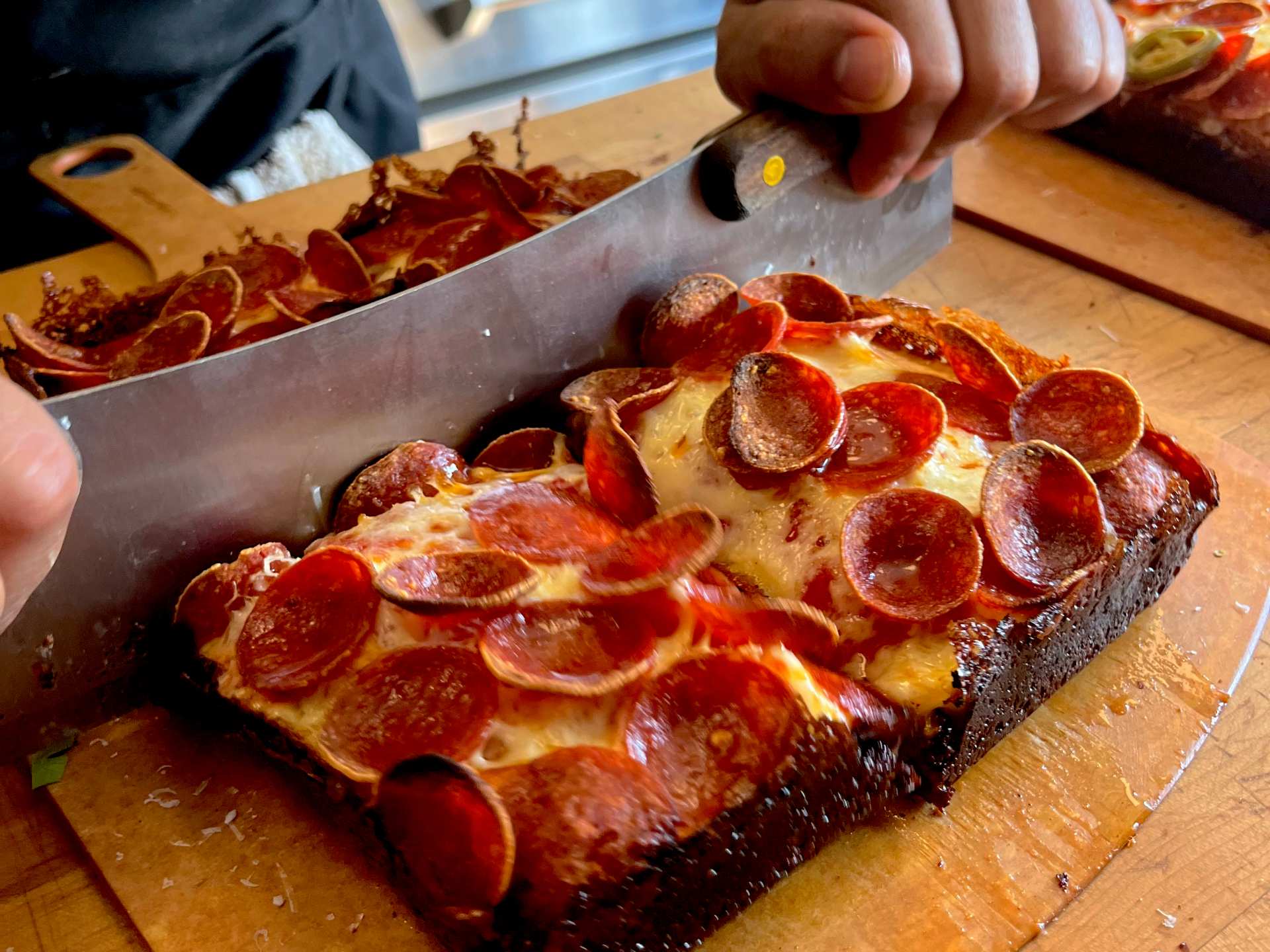 Slicing a Double Trouble pizza at Slowhand Sourdough Pizza Slicing a Double Trouble pizza at Slowhand Sourdough Pizza