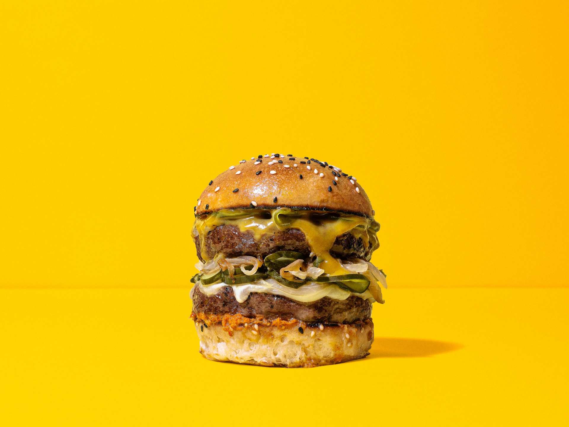 A NotCo double-decker burger on a yellow background A NotCo double-decker burger on a yellow background