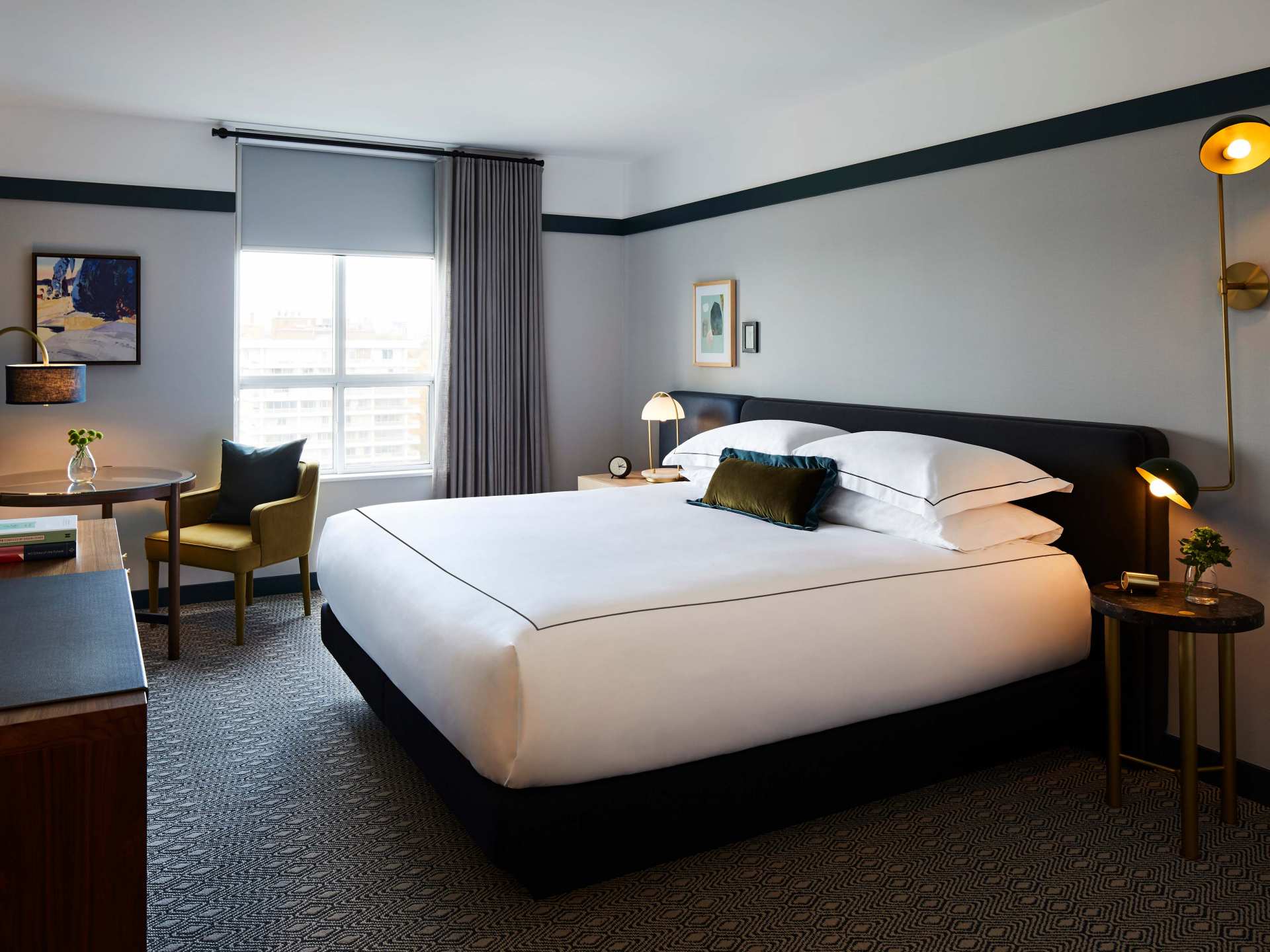 A suite at the Kimpton Saint George hotel with a king-sized bed A suite at the Kimpton Saint George hotel with a king-sized bed