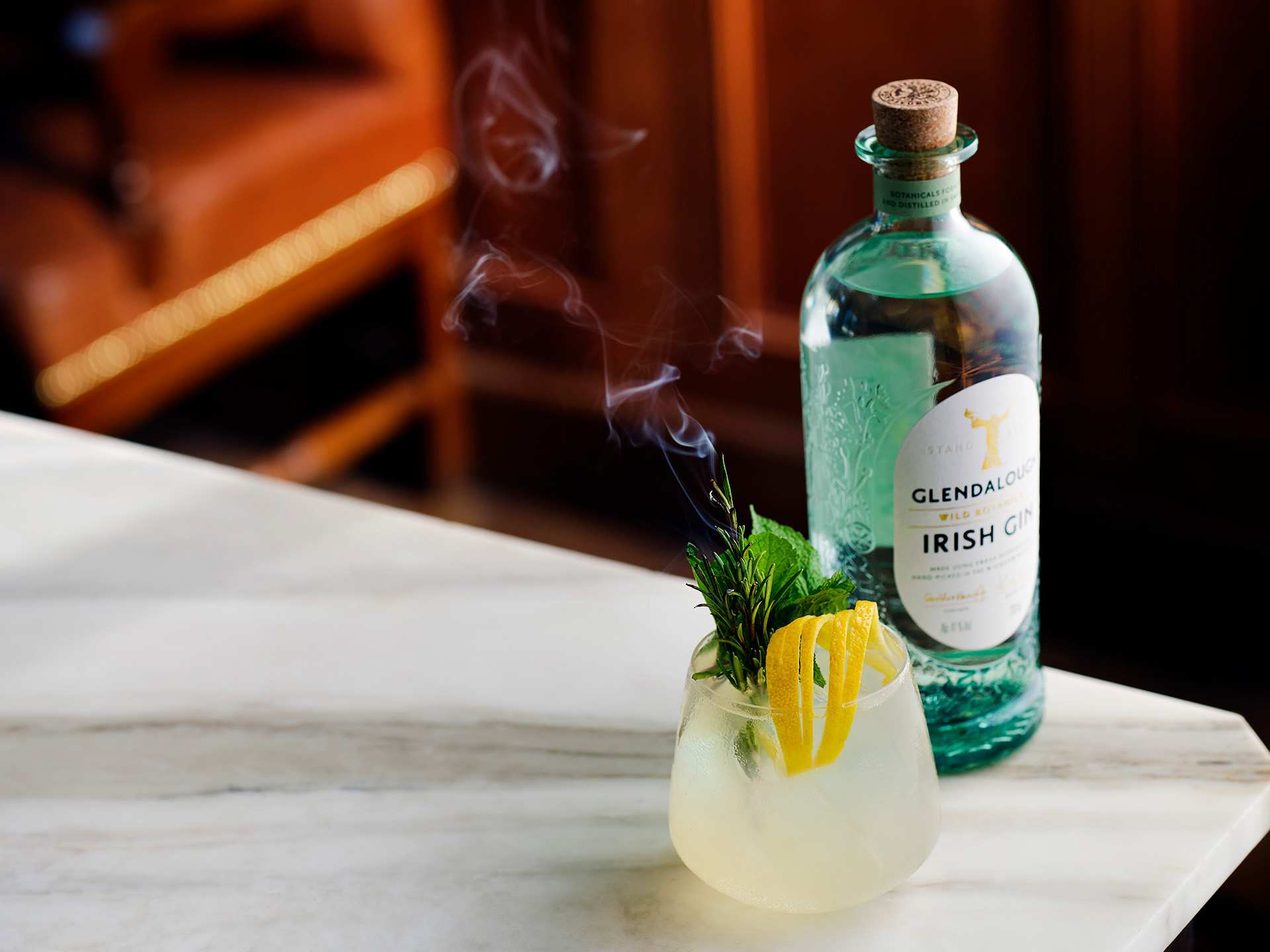 A bottle of Glendalough Irish gin with a yellow cocktail A bottle of Glendalough Irish gin with a yellow cocktail