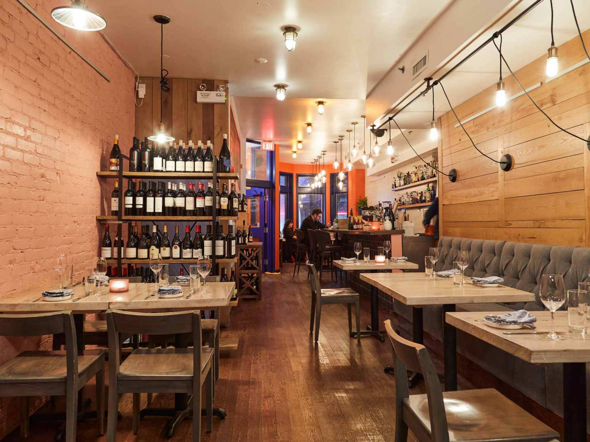 Best wine bars in Toronto | The dining room and a shelf of wine at Sommelier Factory