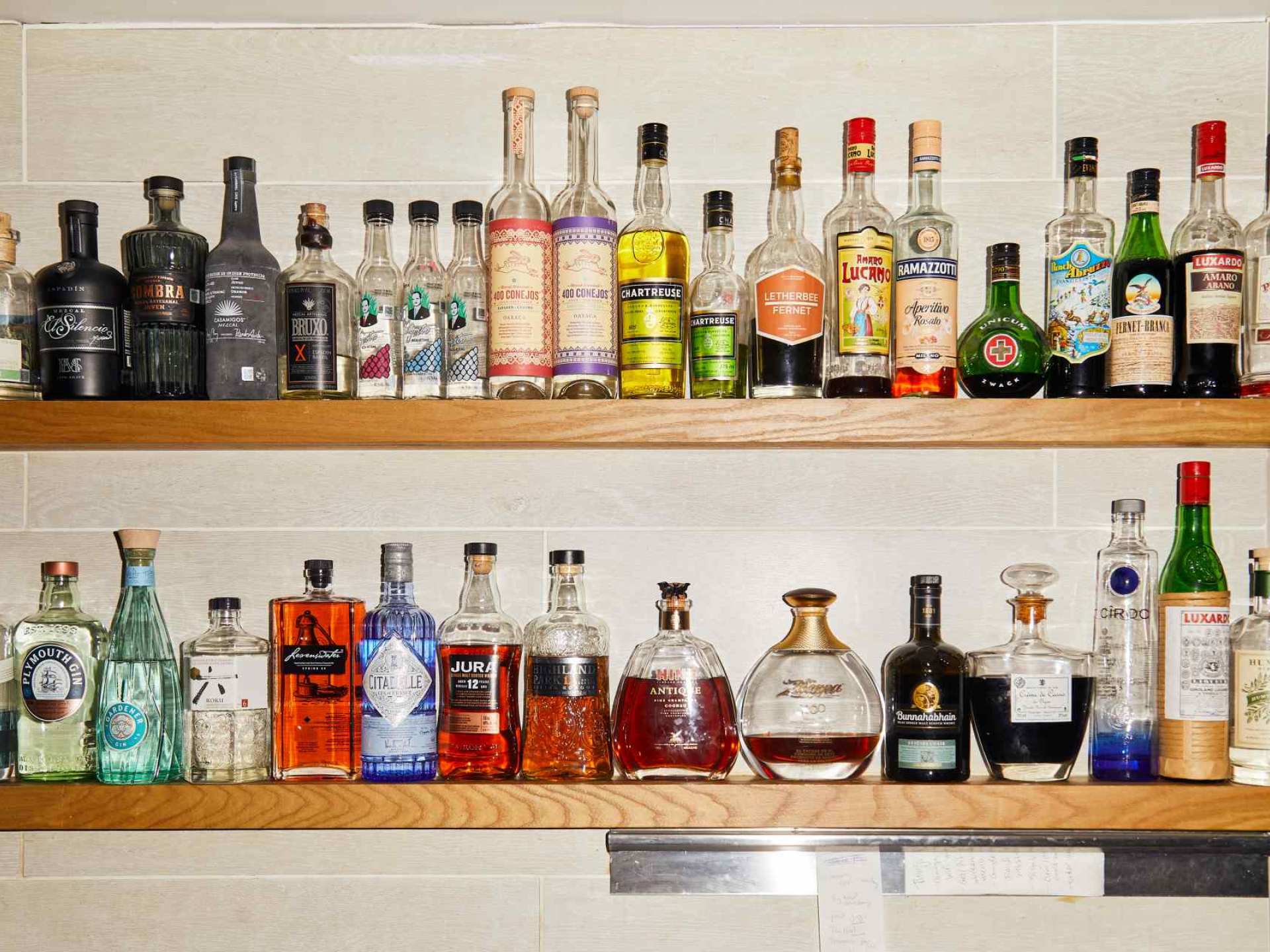 Best wine bars in Toronto | The spirits shelf behind the bar at Sommelier Factory