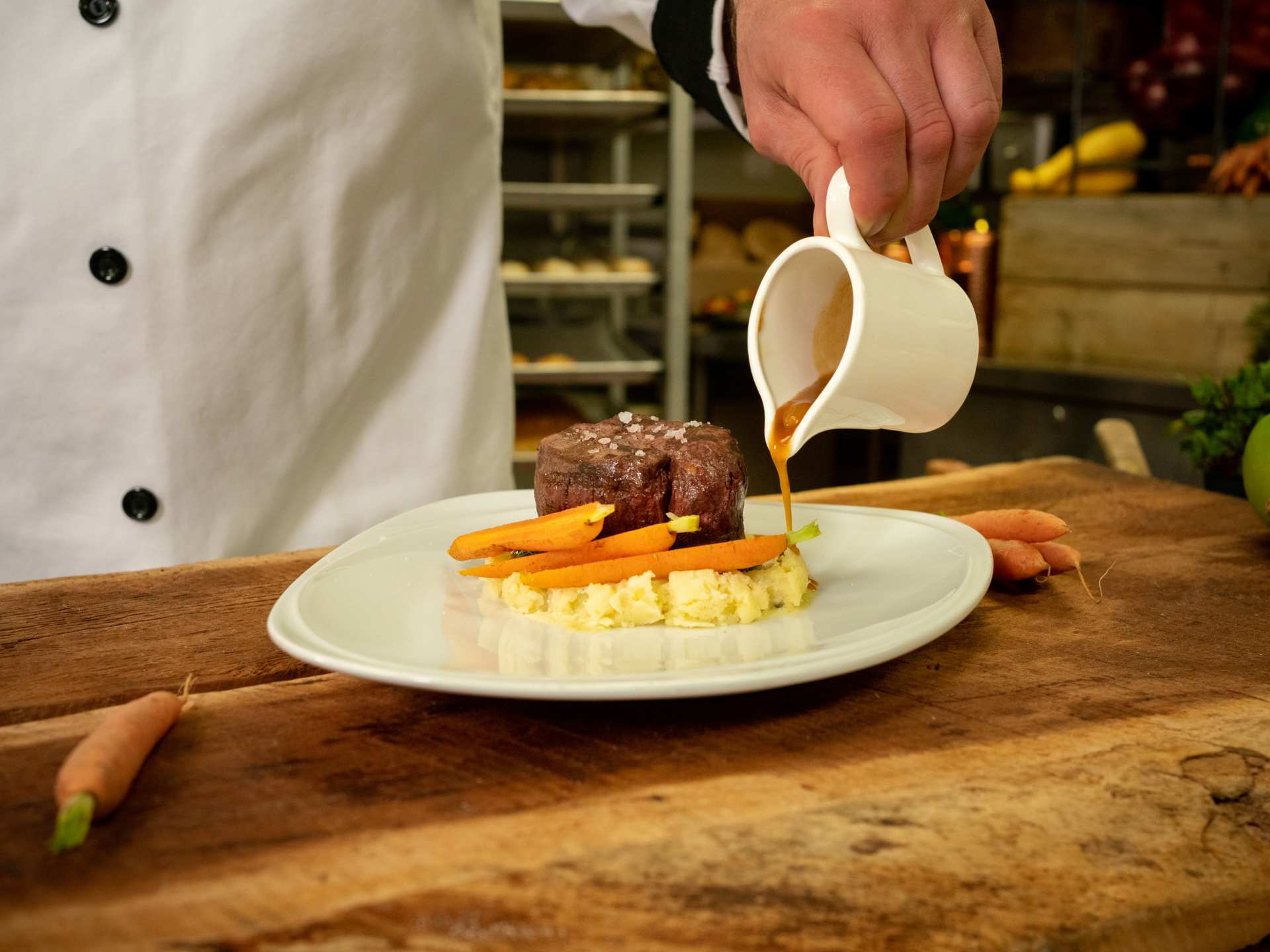 Niagara Park | A chef pours gravy onto a dish at Table Rock House Restaurant Niagara Park | A chef pours gravy onto a dish at Table Rock House Restaurant
