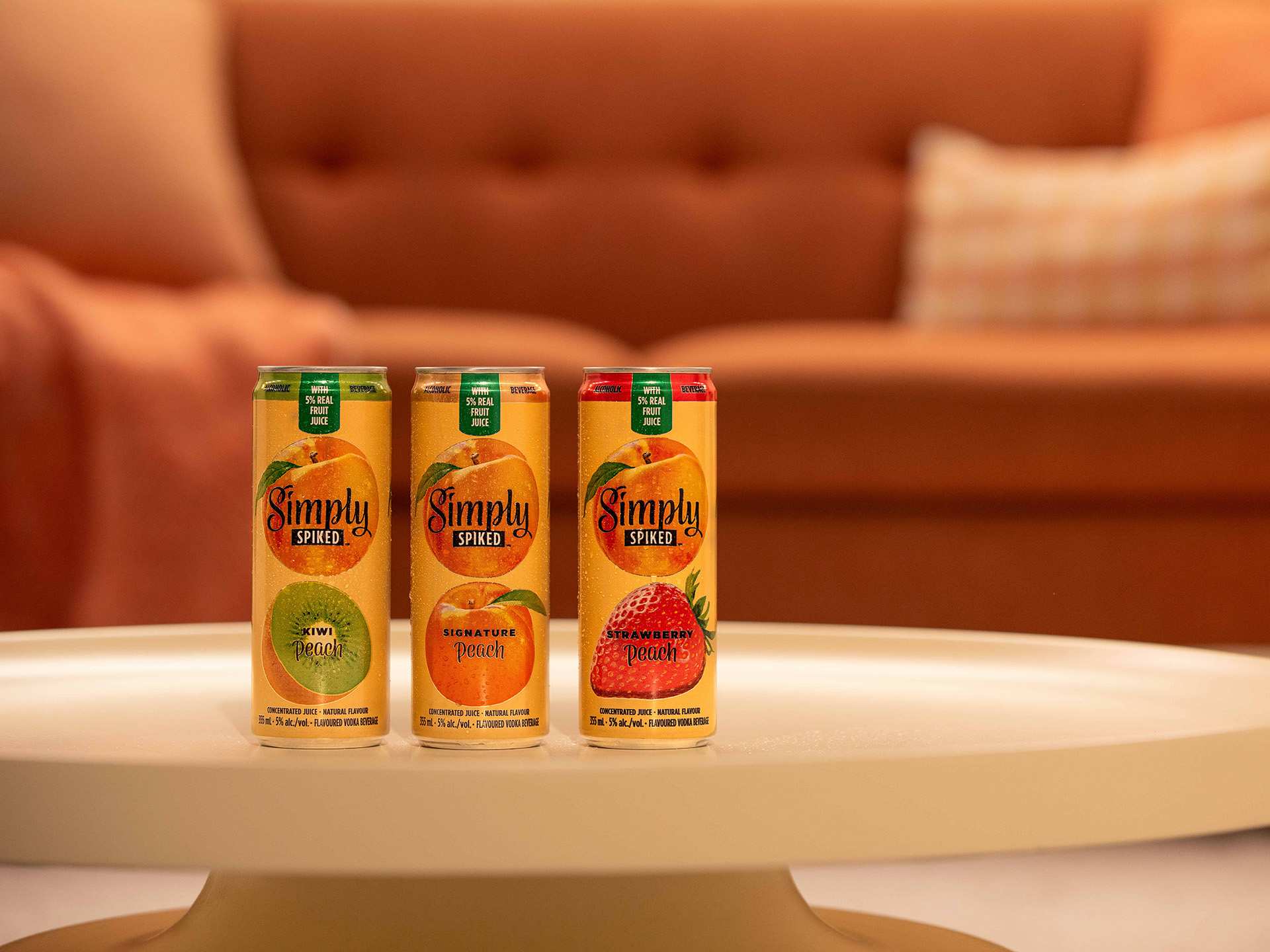 Three cans of Simply Spiked peach flavours