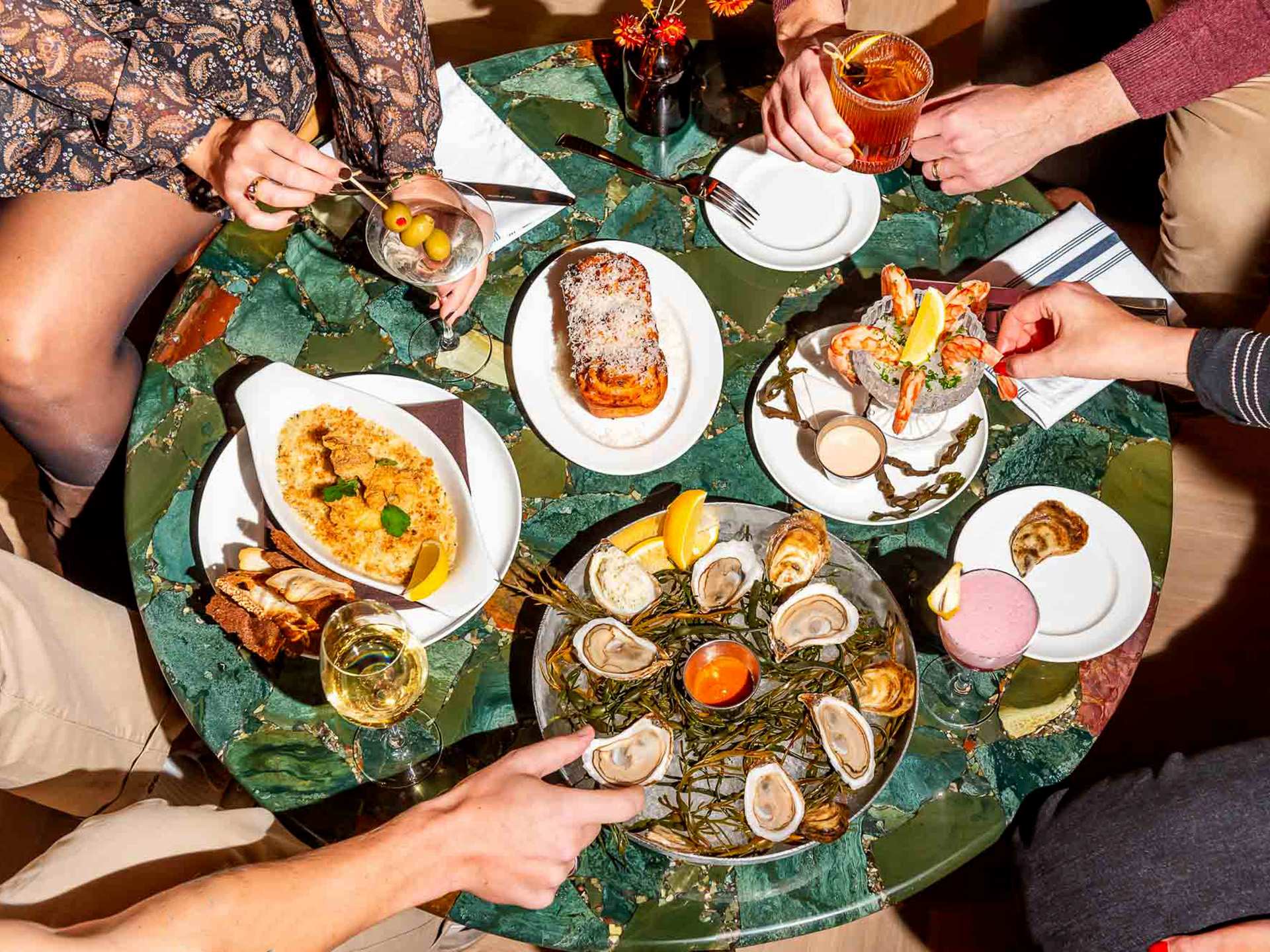 The best downtown Toronto restaurants | People enjoying different plates of food at The Joneses