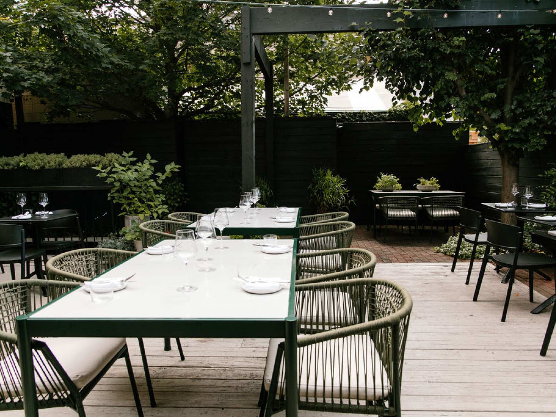 Tables and chairs on the patio at Henry's restaurant Toronto