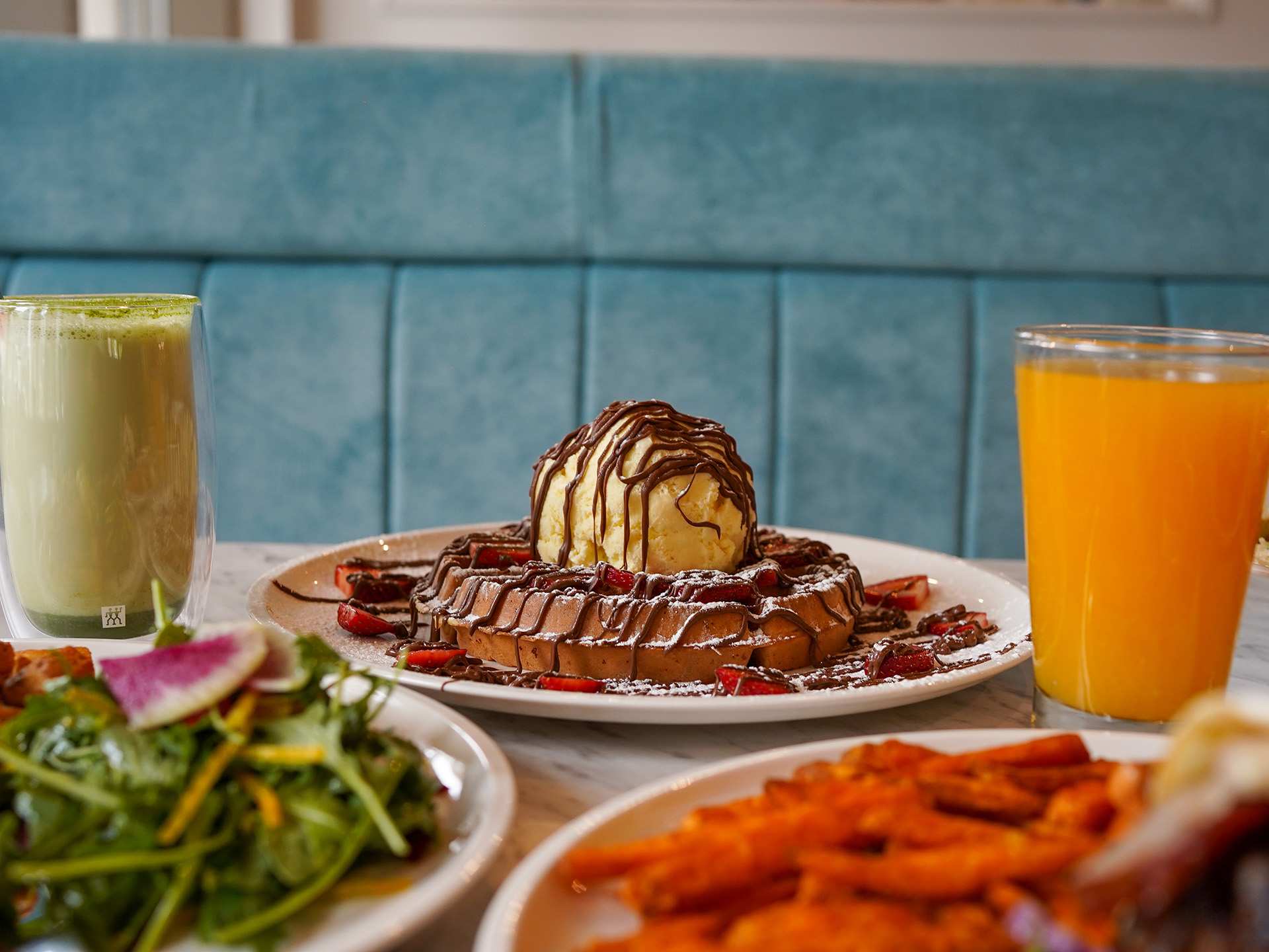 The best brunch in Toronto | A chocolate-drizzled waffle topped with ice cream and with juice