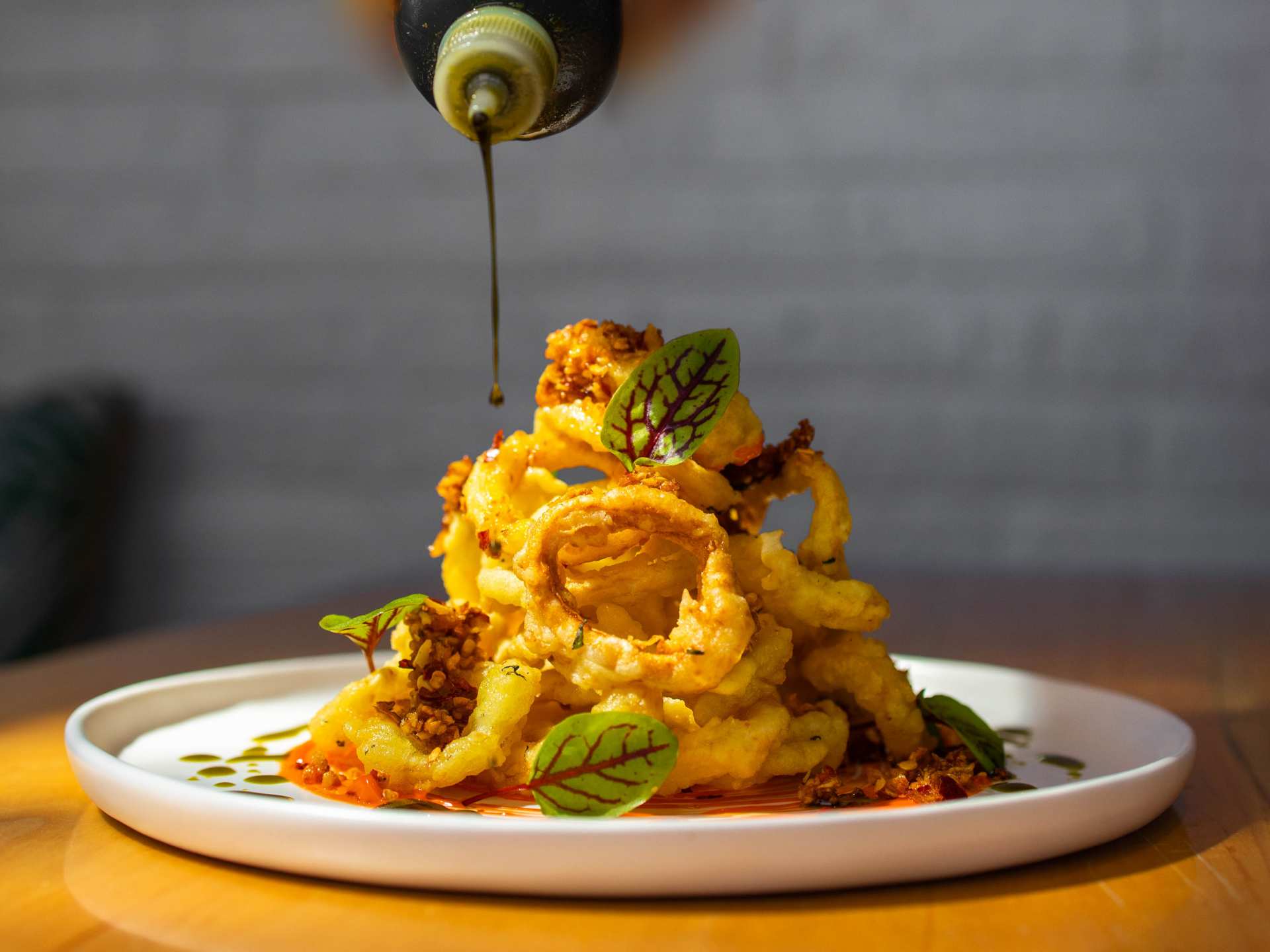 Summerlicious Toronto | Drizzling sauce on a dish at The Cottage Cheese in Kensington Market, Toronto