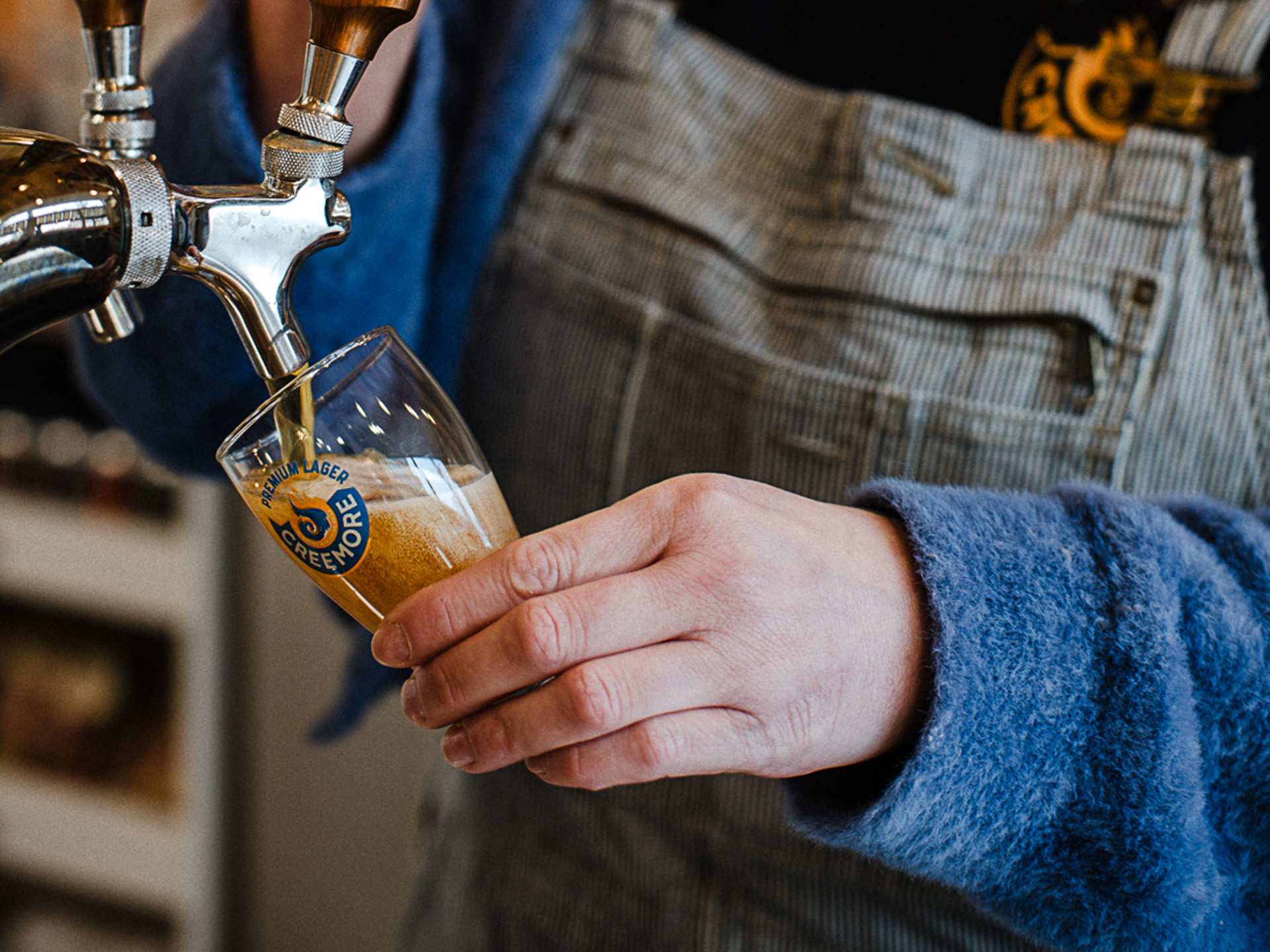 Pouring a Creemore Springs Brewery beer Pouring a Creemore Springs Brewery beer