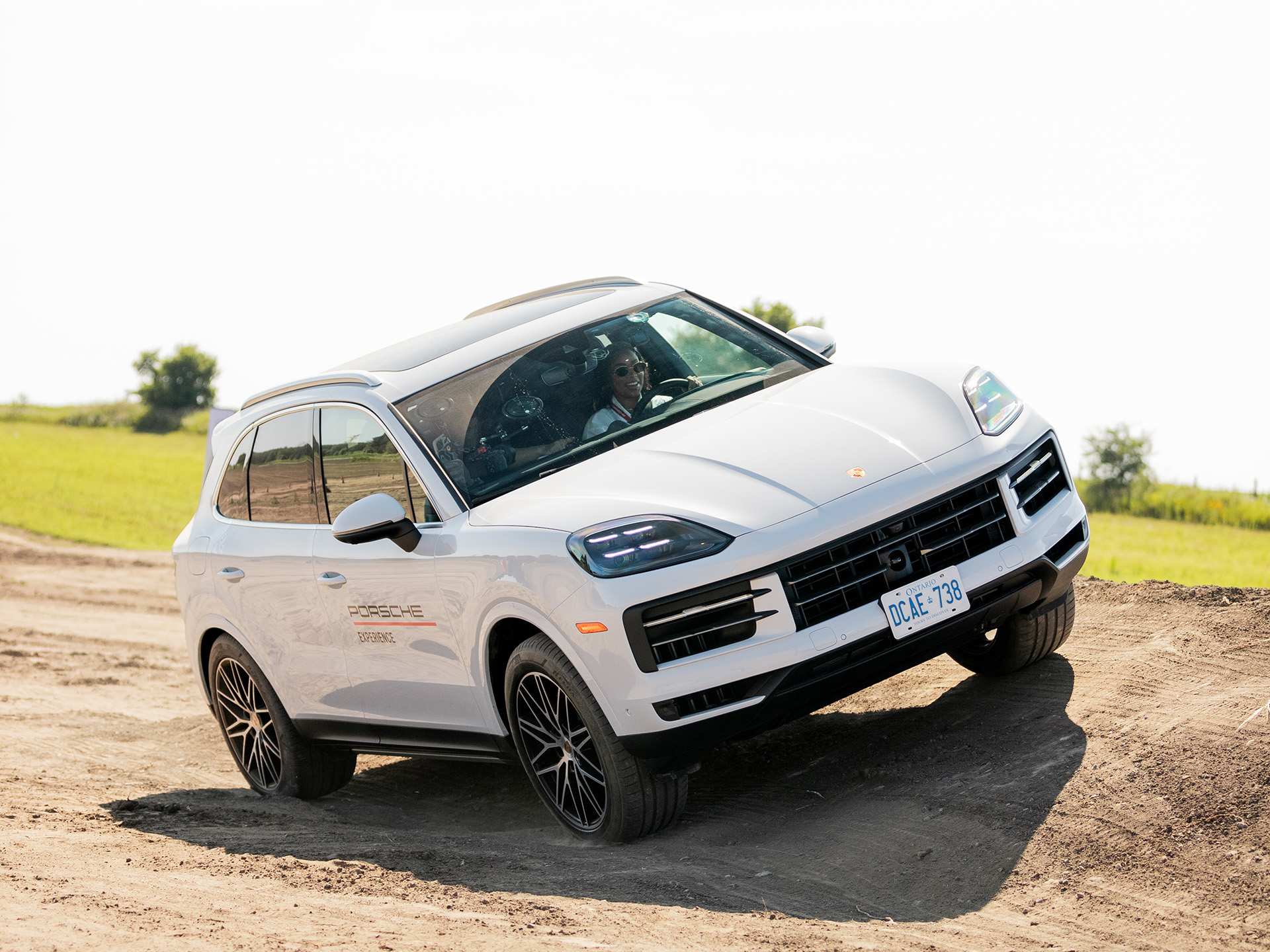 A white Porsche Cayenne on a hill A white Porsche Cayenne on a hill