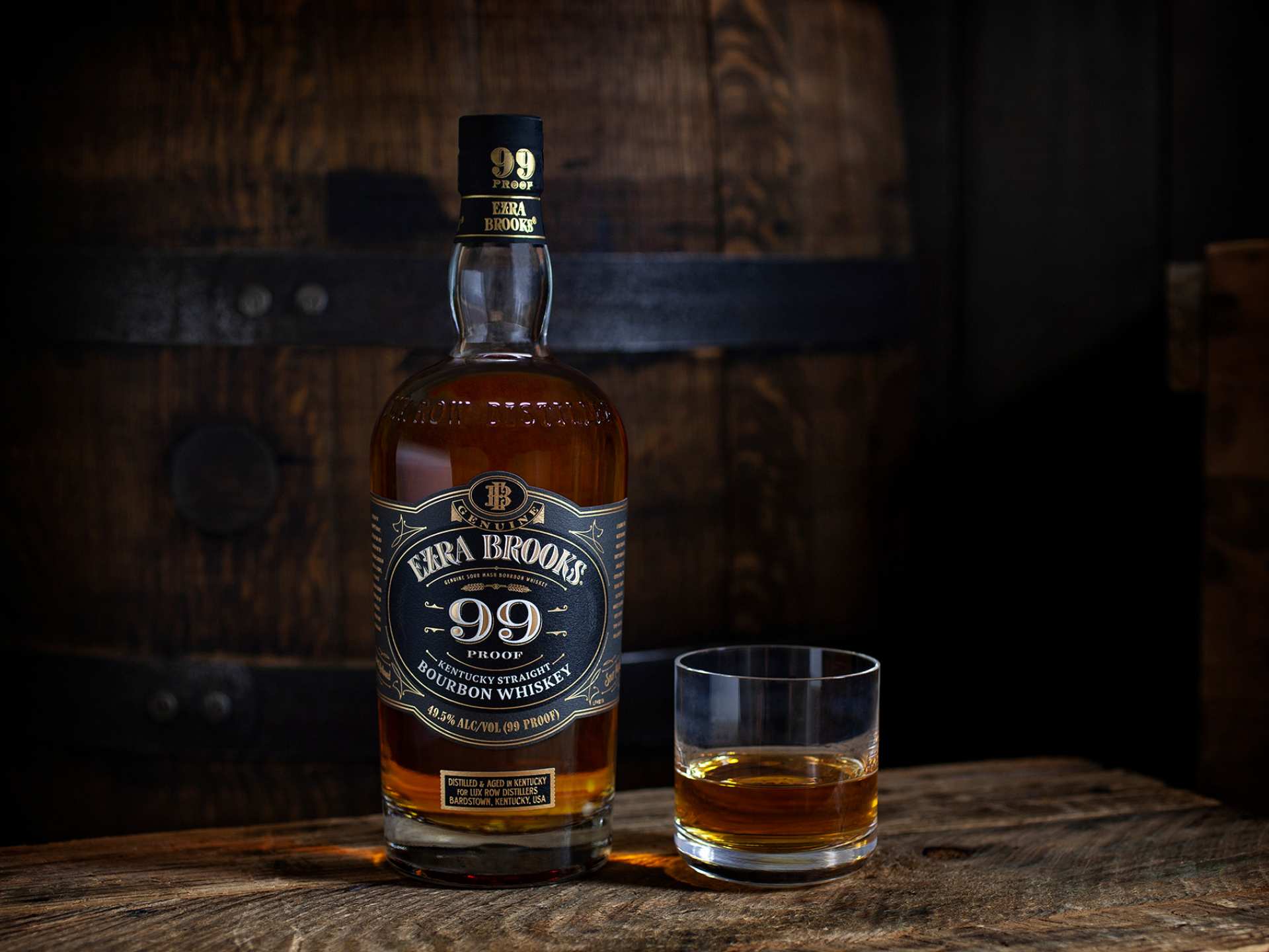 A bottle of Ezra Brooks 99 and a glass of bourbon A bottle of Ezra Brooks 99 and a glass of bourbon
