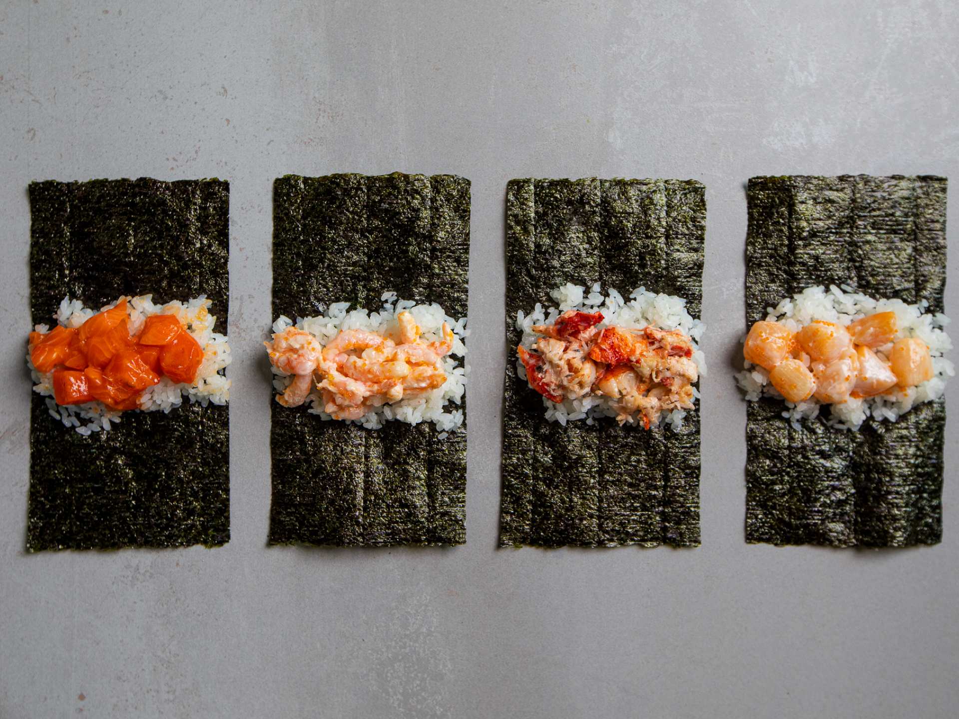 Hello Nori the Hand Roll Bar, Toronto | Four handrolls lay unwrapped at Hello Nori
