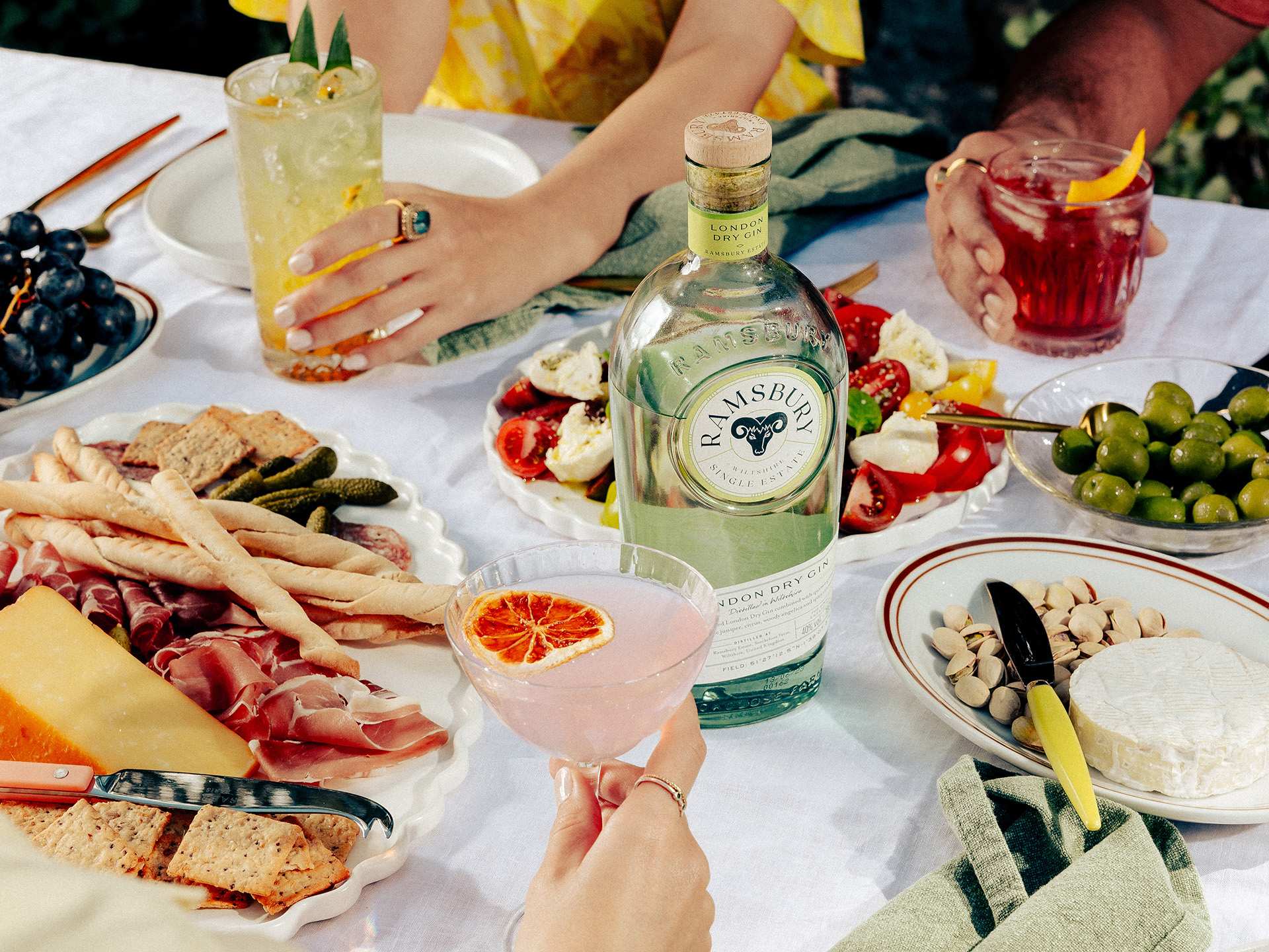 A bottle of Ramsbury London dry gin with charcuterie and snacks