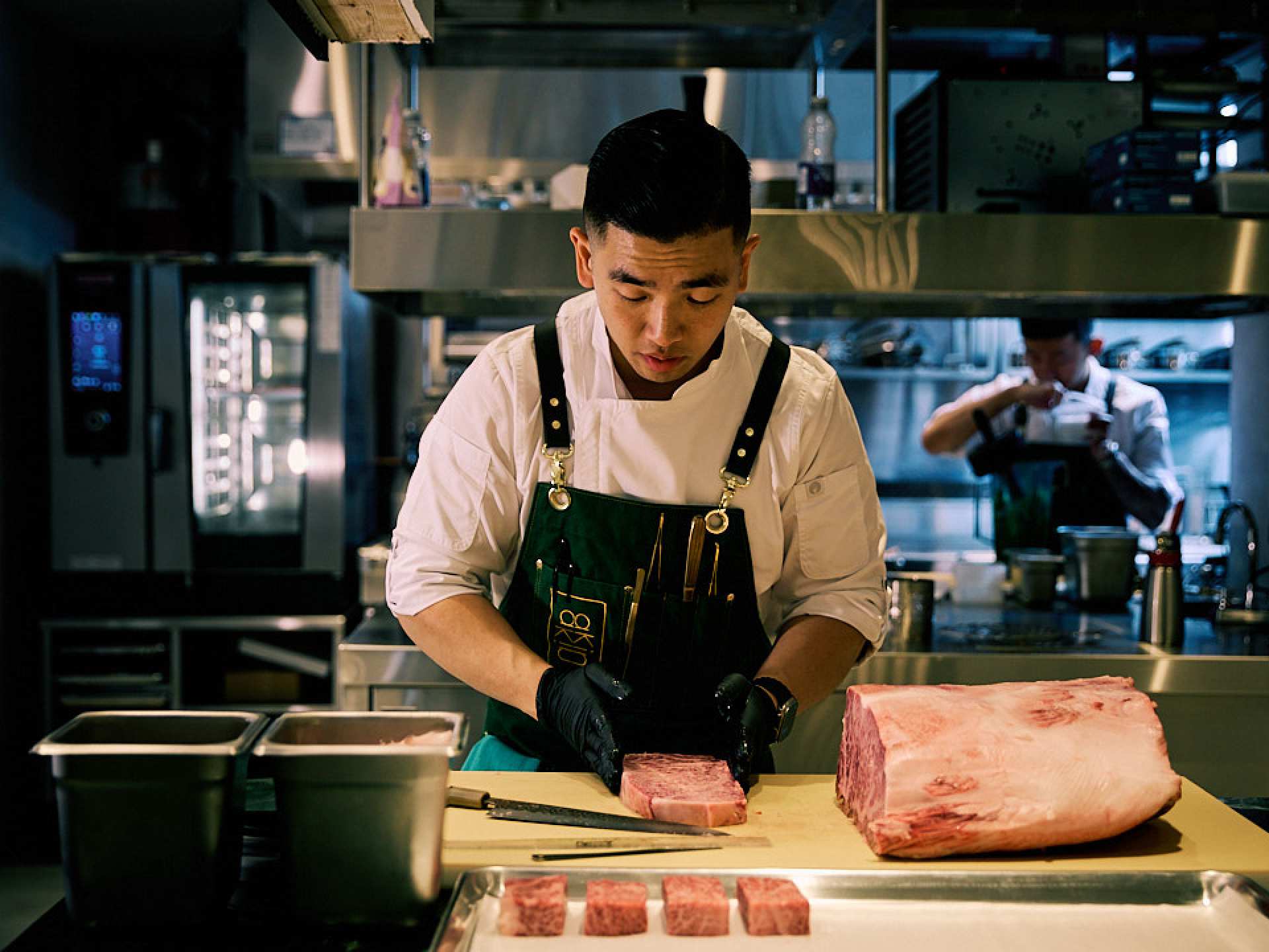 Best new restaurants Toronto | A chef prepares meat at Akin restaurant in Toronto