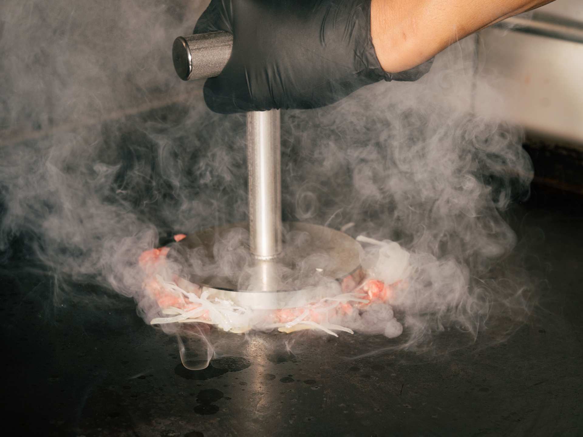 The best burgers in Toronto | Pressing a smash burger at Bindi's Burgers