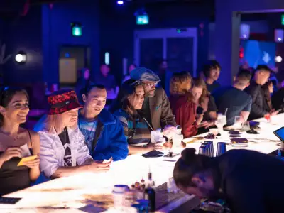Happy Hour Toronto | Guests leaning over the bar at Offworld for happy hour