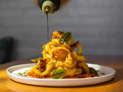 Summerlicious Toronto | Drizzling sauce on a dish at The Cottage Cheese in Kensington Market, Toronto